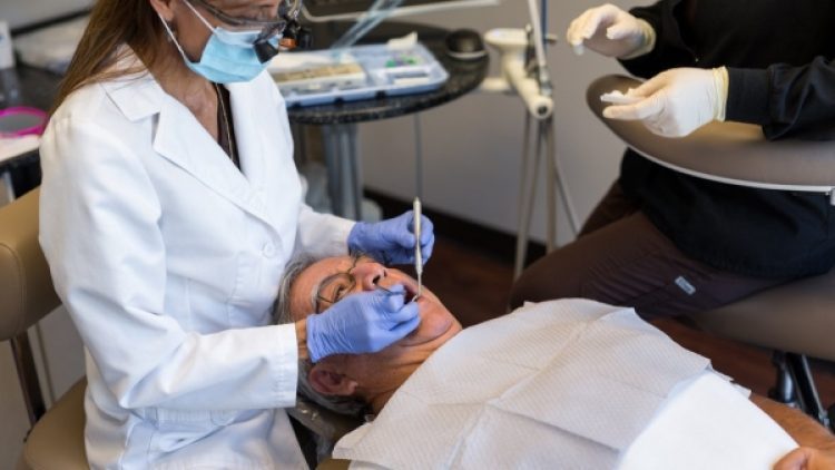 A female dentist treating her patient
